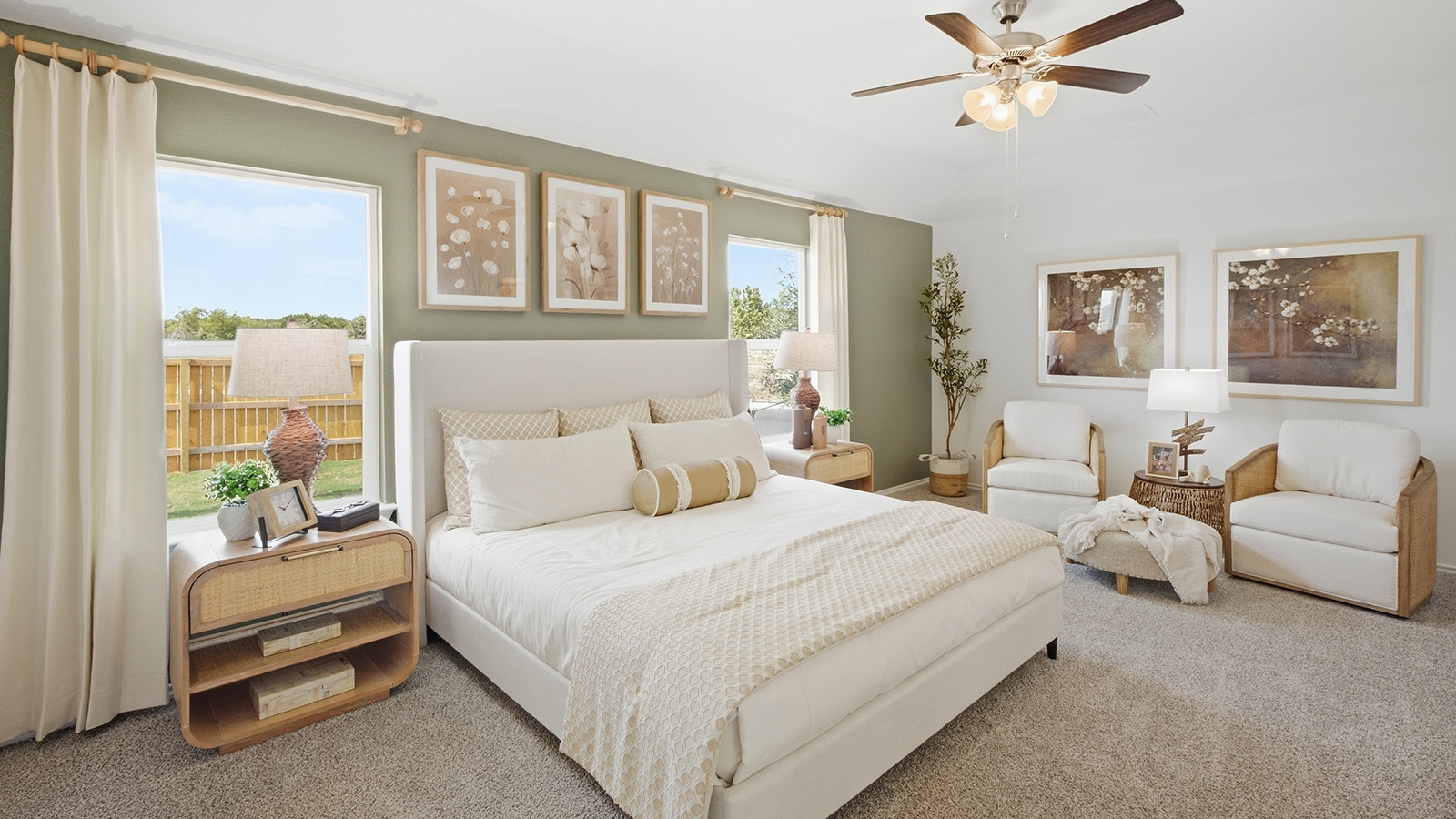 Wildwood Model primary bedroom with carpeted flooring and windows for natural lighting.