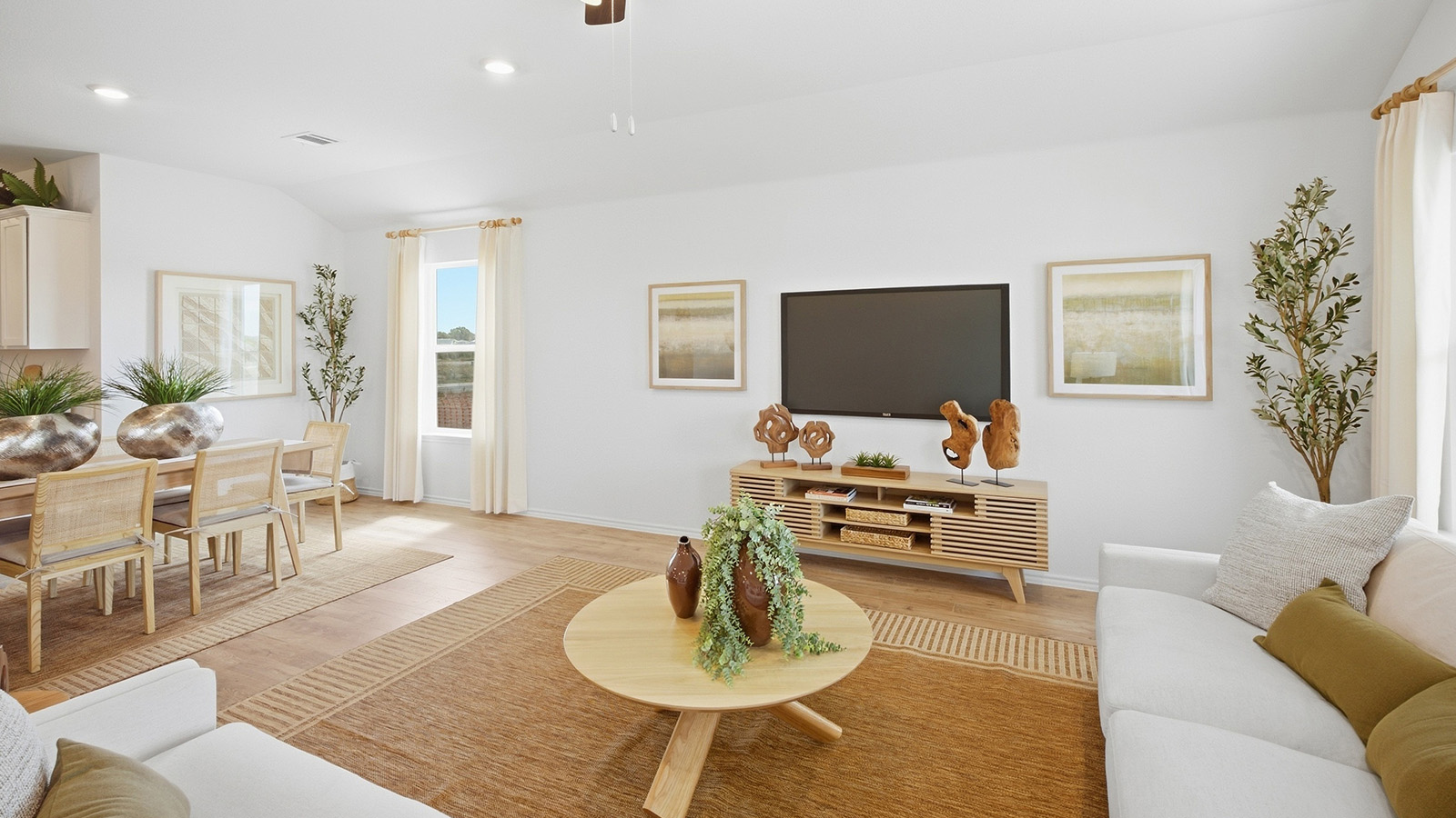 Wildwood Model living room with view of open concept dining room and kitchen.