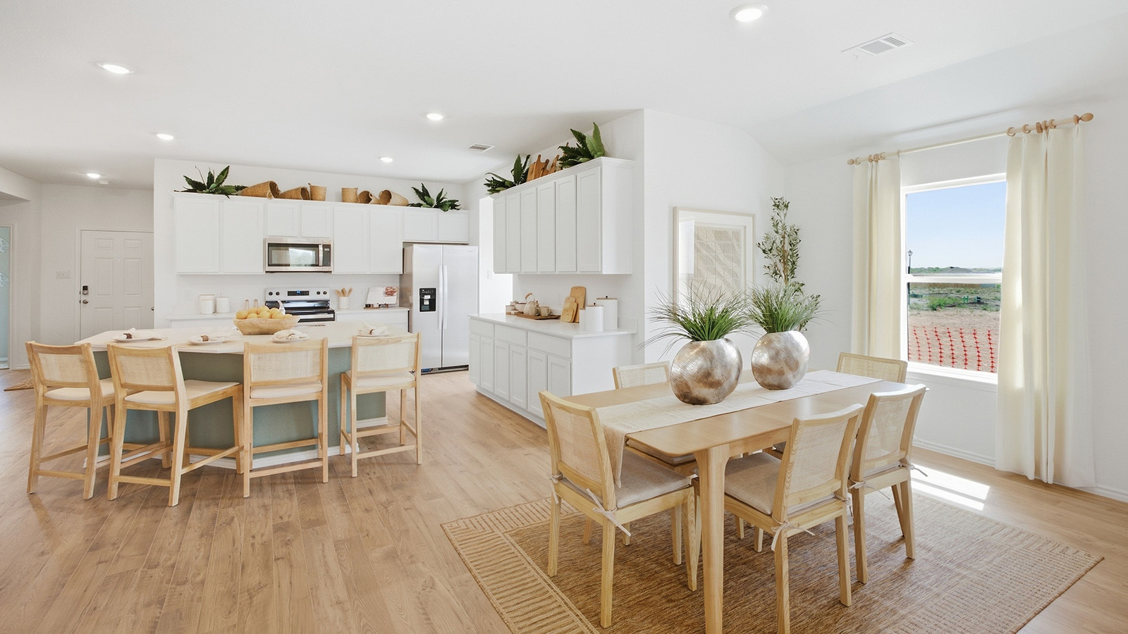 Wildwood Model dining room with window for natural lighting and view of open concept kitchen.