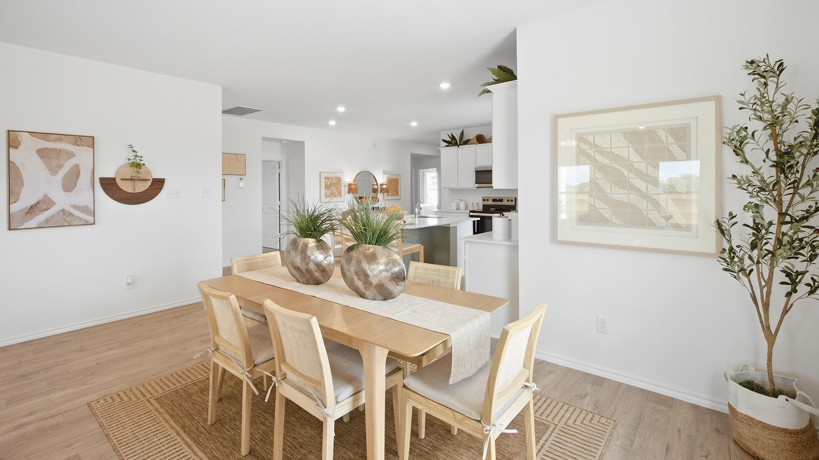 Wildwood Model dining room with dining room table and view of open concept kitchen.