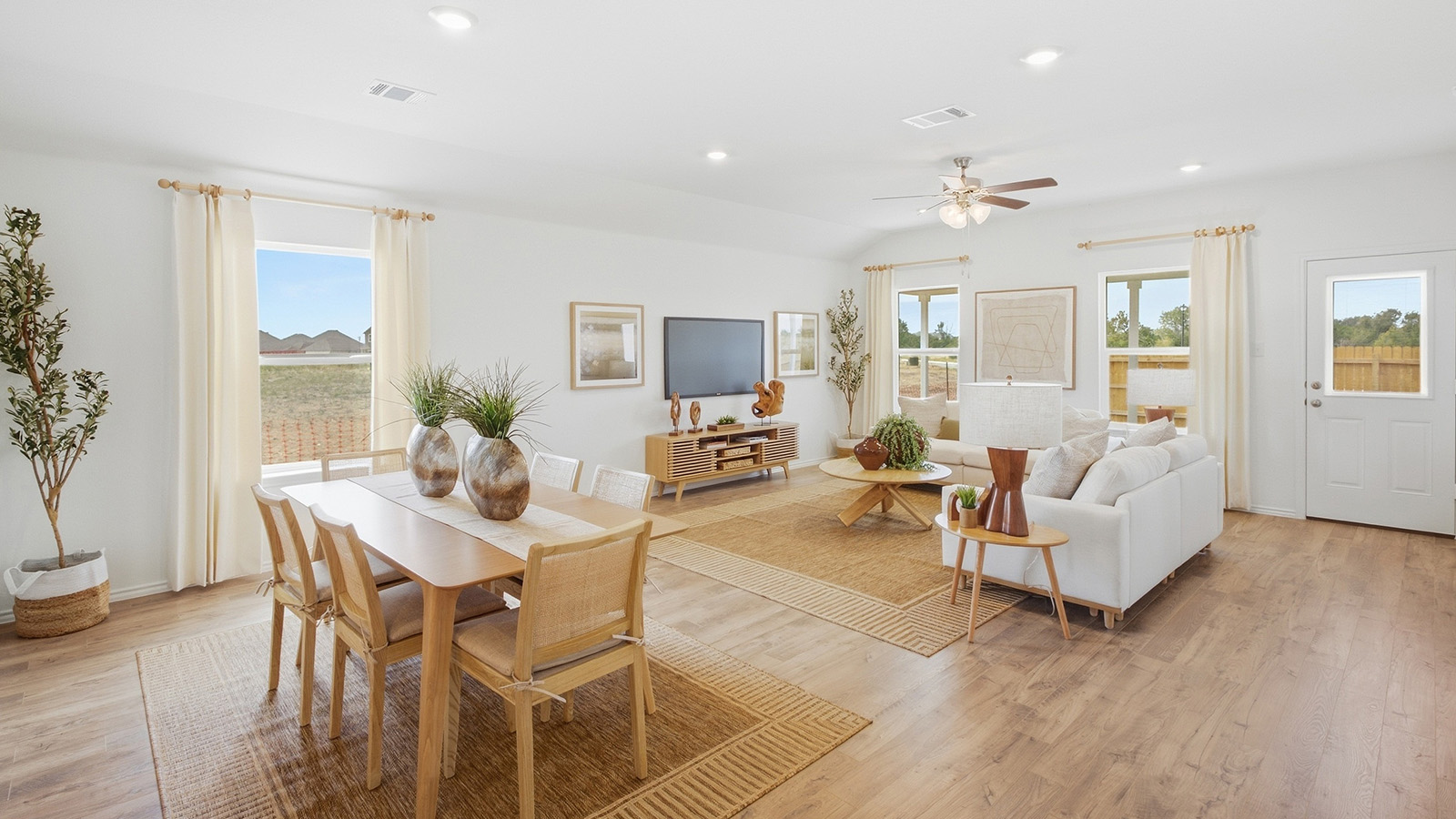 Wildwood Model dining room with window for natural lighting and view of open concept living room.