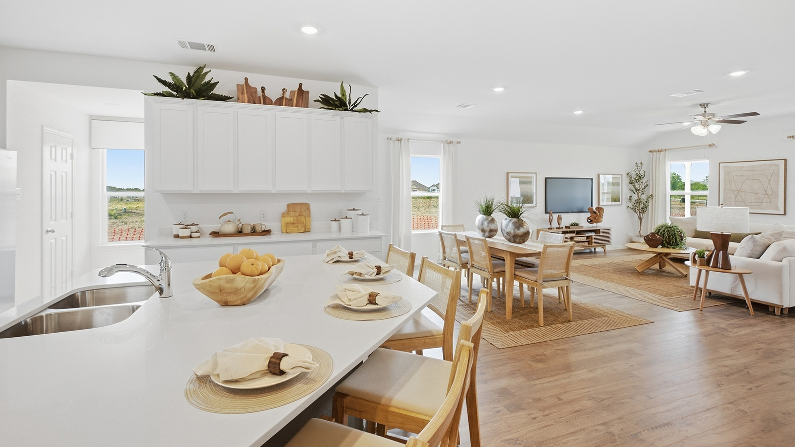 Wildwood Model kitchen with kitchen island with white cabinets and granite countertops..