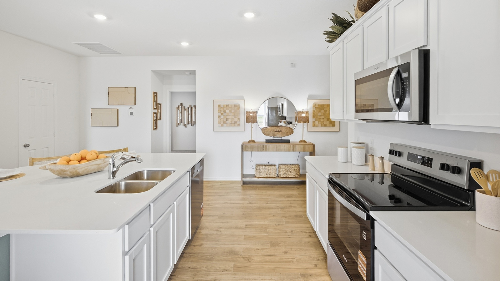 Wildwood Model kitchen with kitchen island with white cabinets and granite countertops.