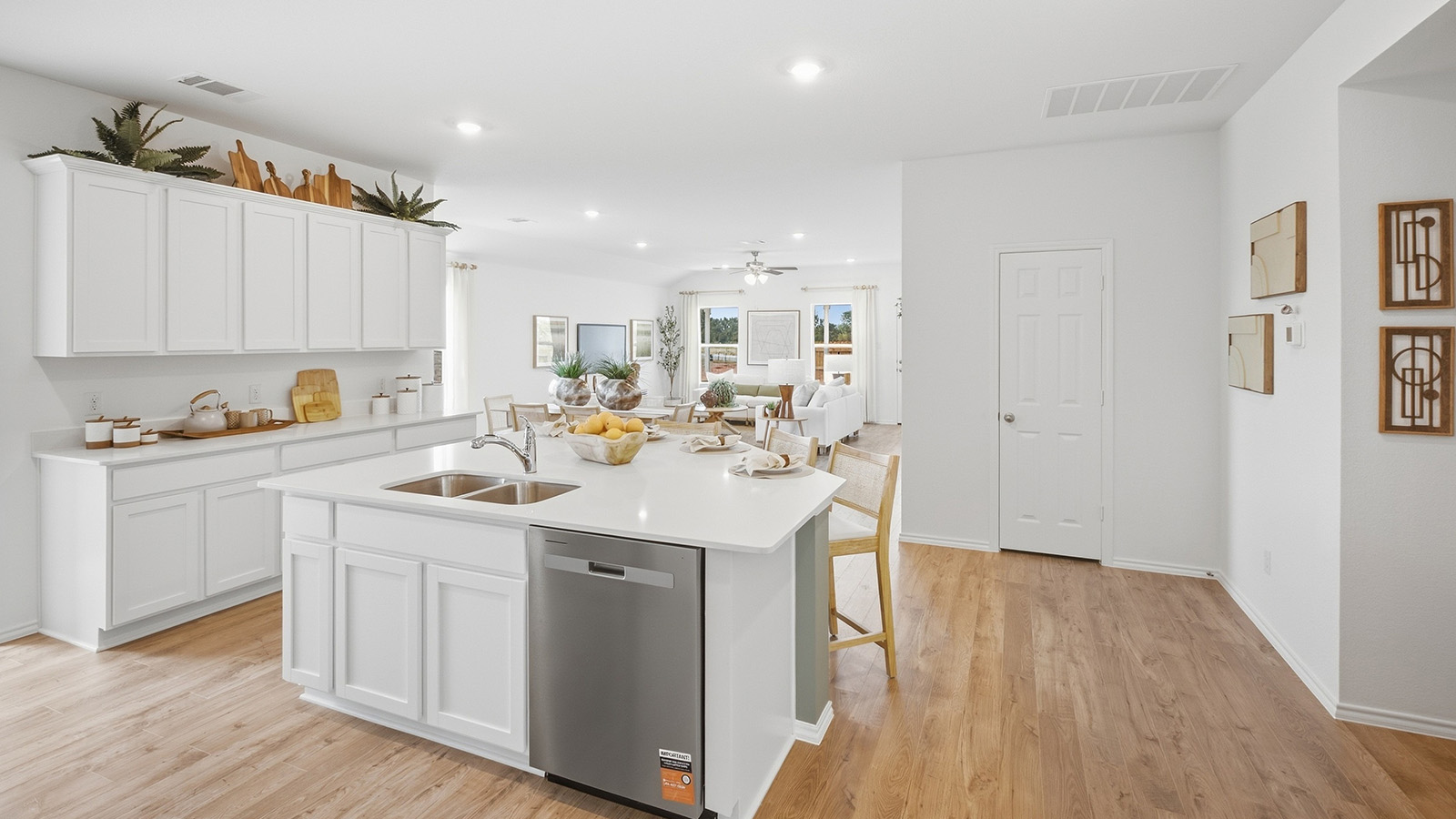 Wildwood Model kitchen with kitchen island with white cabinets and granite countertops.
