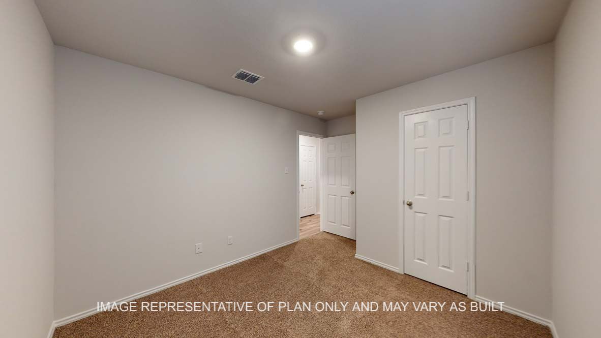 Ashburn secondary bedroom with view to closet door.