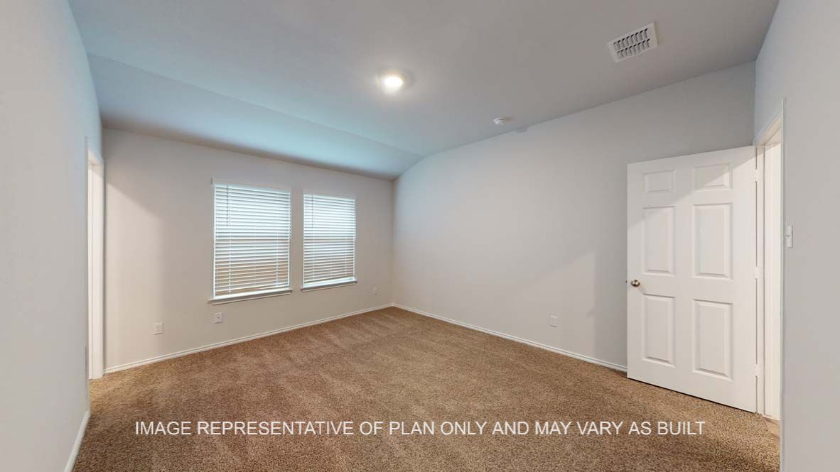Ashburn primary bedroom with carpet flooring and view into connected primary bath.