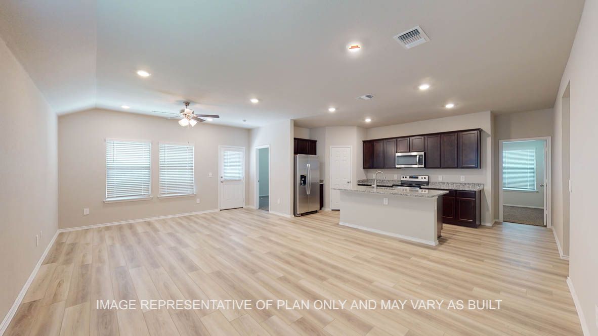 Camden living room with vinyl plank flooring and open concept kitchen.