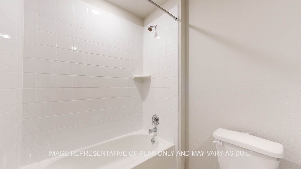 Seabrook secondary bath with combination tub and shower with ceramic tile surround.