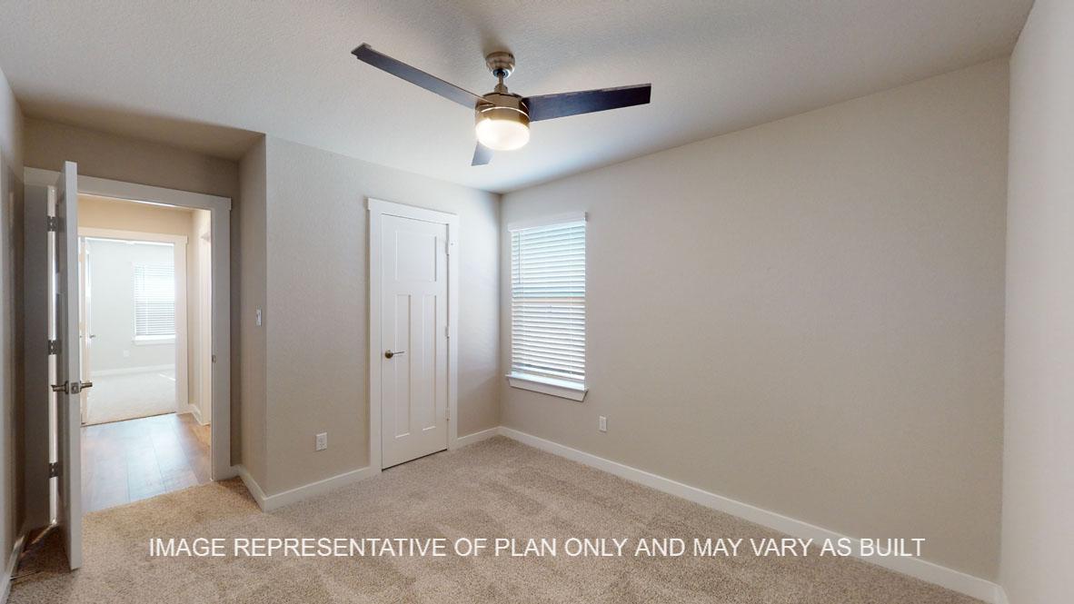 Baxtor secondary bedroom with carpet flooring.