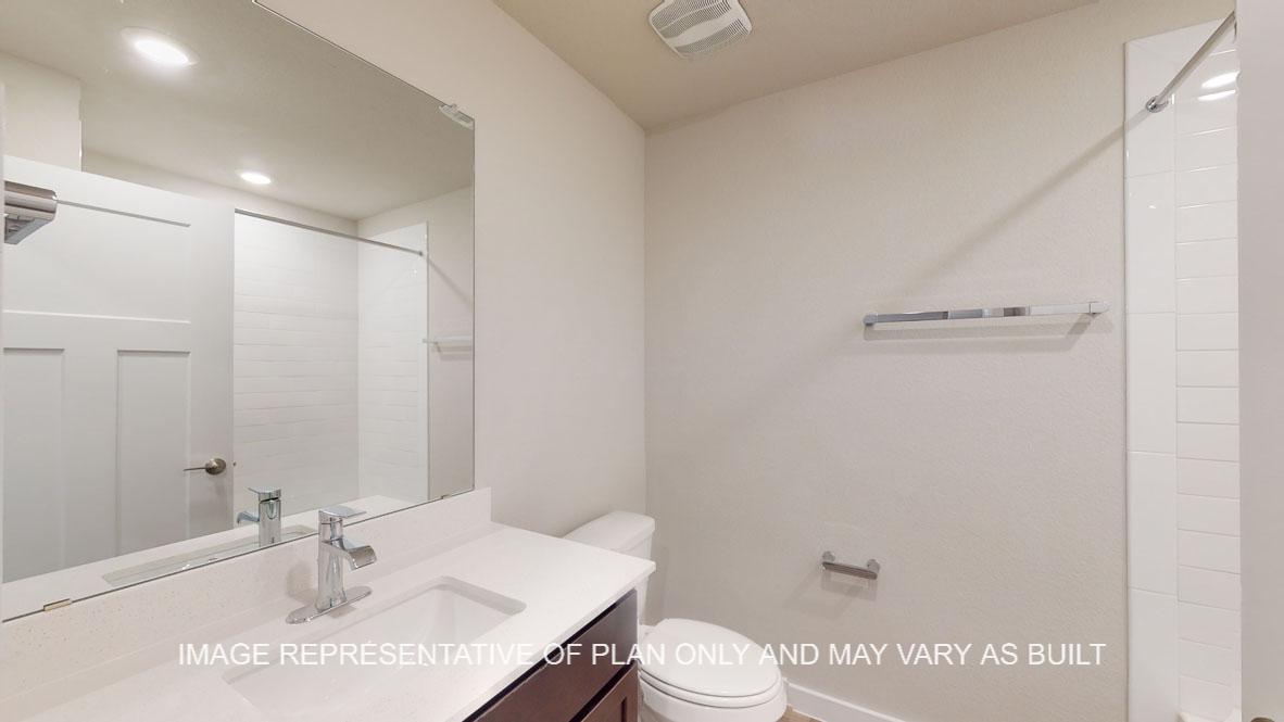 Baxtor secondary bath with single vanity and tub and shower combination.