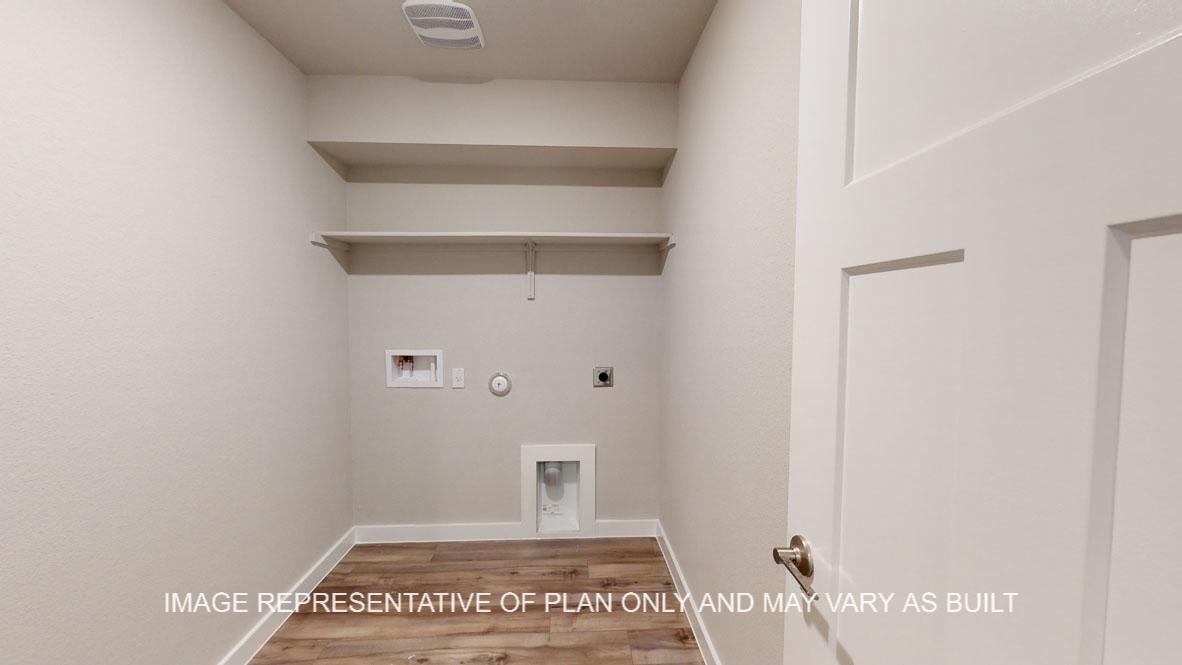 Baxtor utility room with vinyl plank flooring.