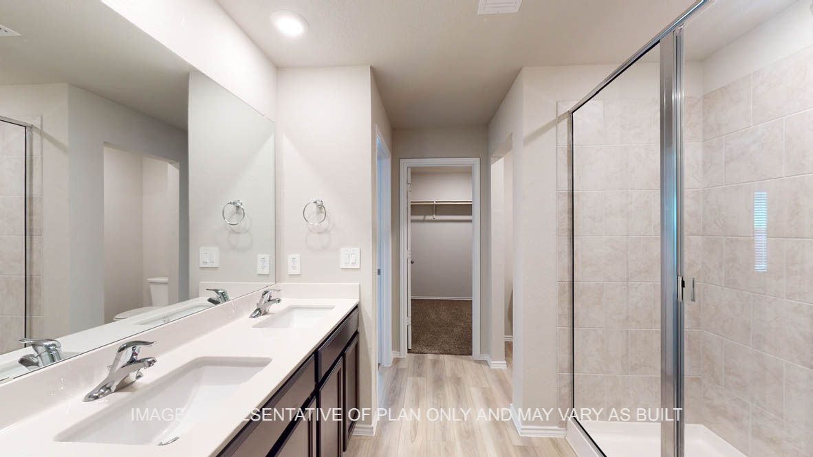 Camden primary bath with clear shower glass enclosure and ceramic tile surround on shower,