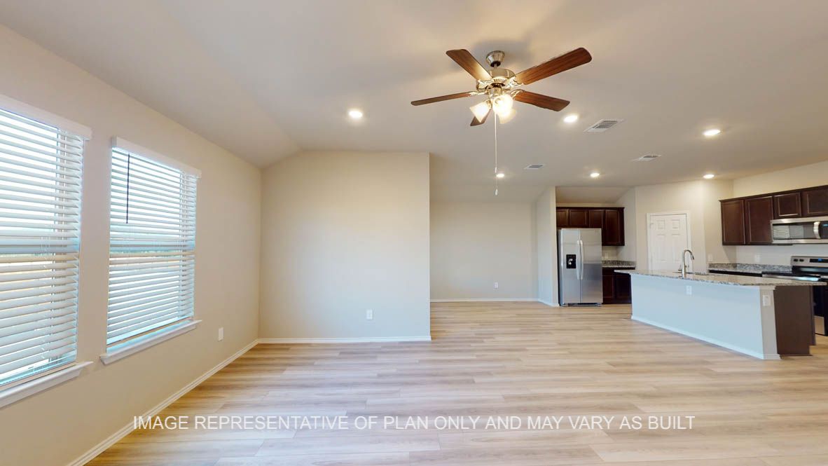 Texas Cali open concept dining room and living room with vinyl plank flooring throughout.