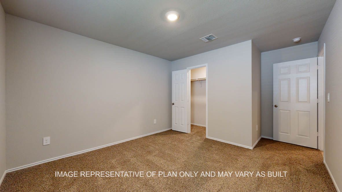 Seabrook secondary bedroom with carpet flooring and closet door.