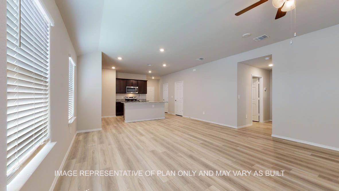 Seabrook living room with vinyl plank flooring with view into kitchen.