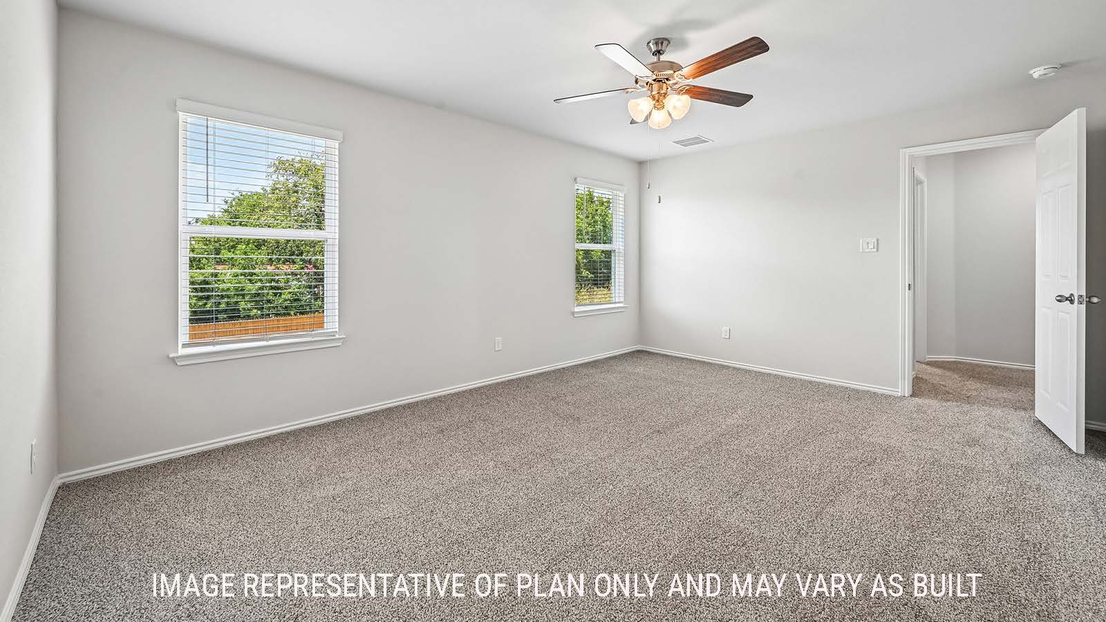 Madison primary bedroom with carpeted flooring and windows for natural lighting.