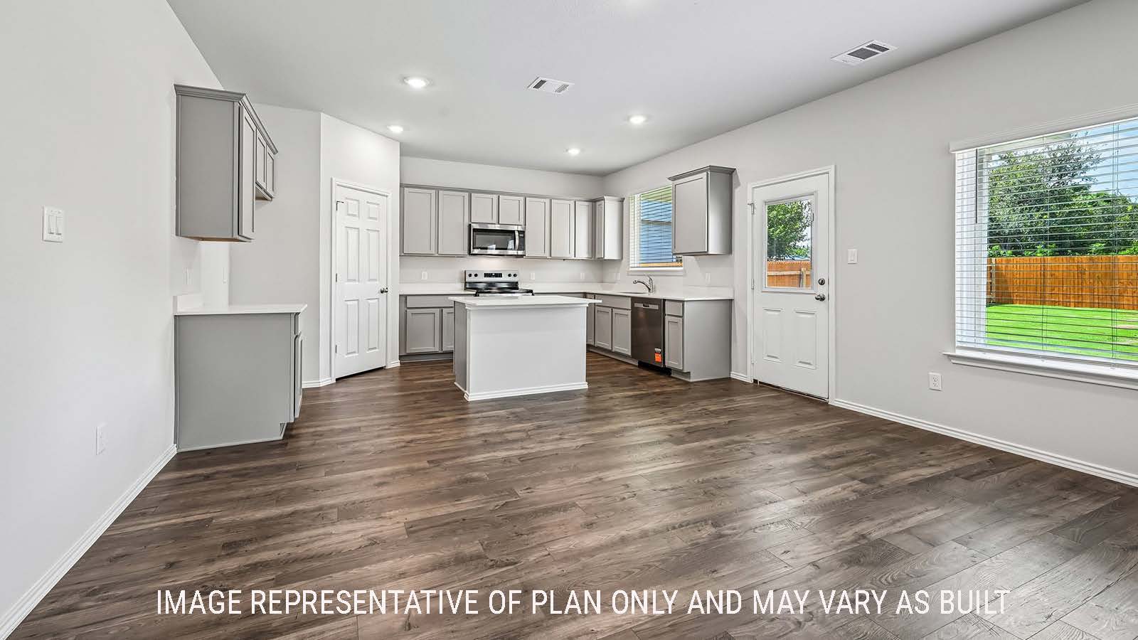Madison dining room with view of open concept kitchen and windows for natural lighting.