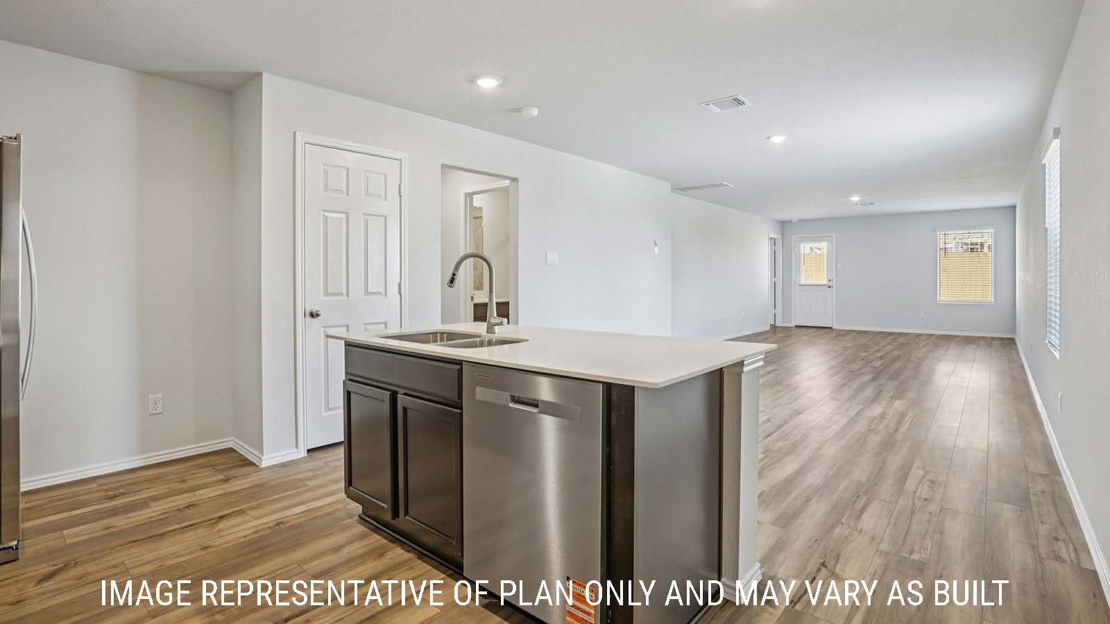 Caprock kitchen with kitchen island and view of open concept dining room and living room.