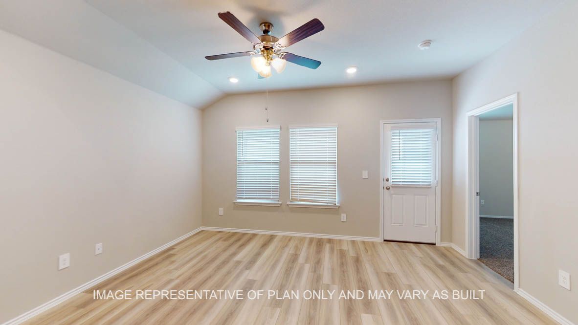 Camden dining room with vinyl plank flooring and windows to the backyard.