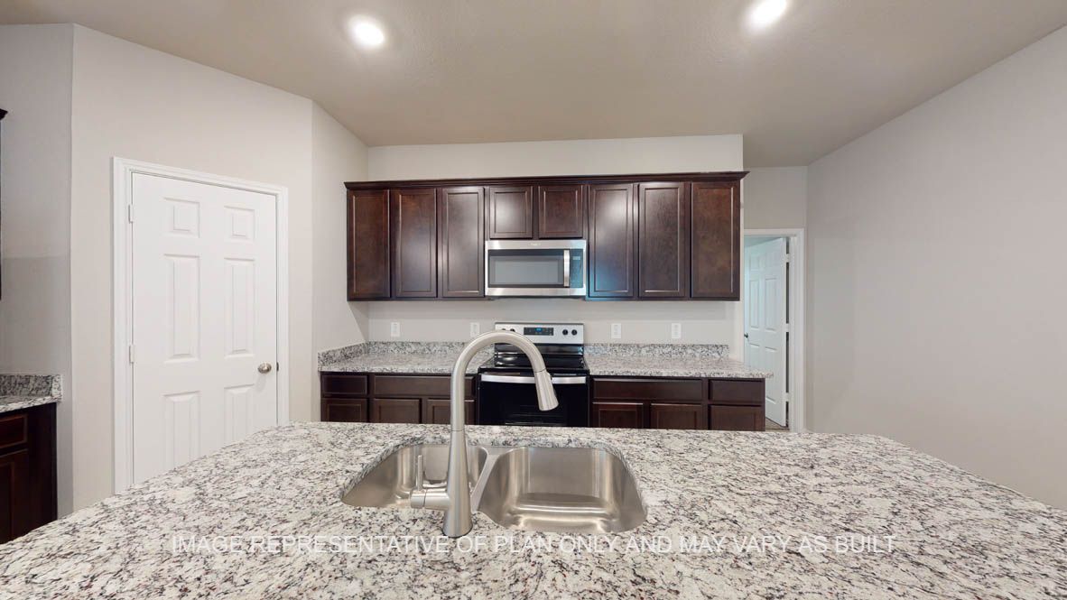 Camden kitchen with dark cabinets and granite countertops.