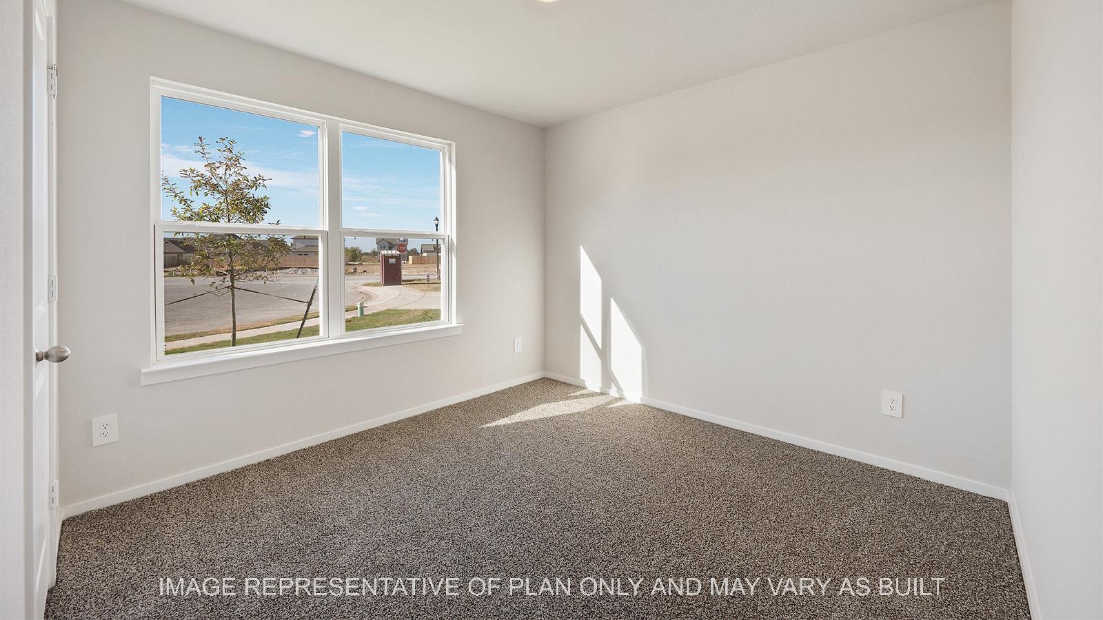 Lakeway secondary bedroom with carpeted flooring and windows for natural lighting.