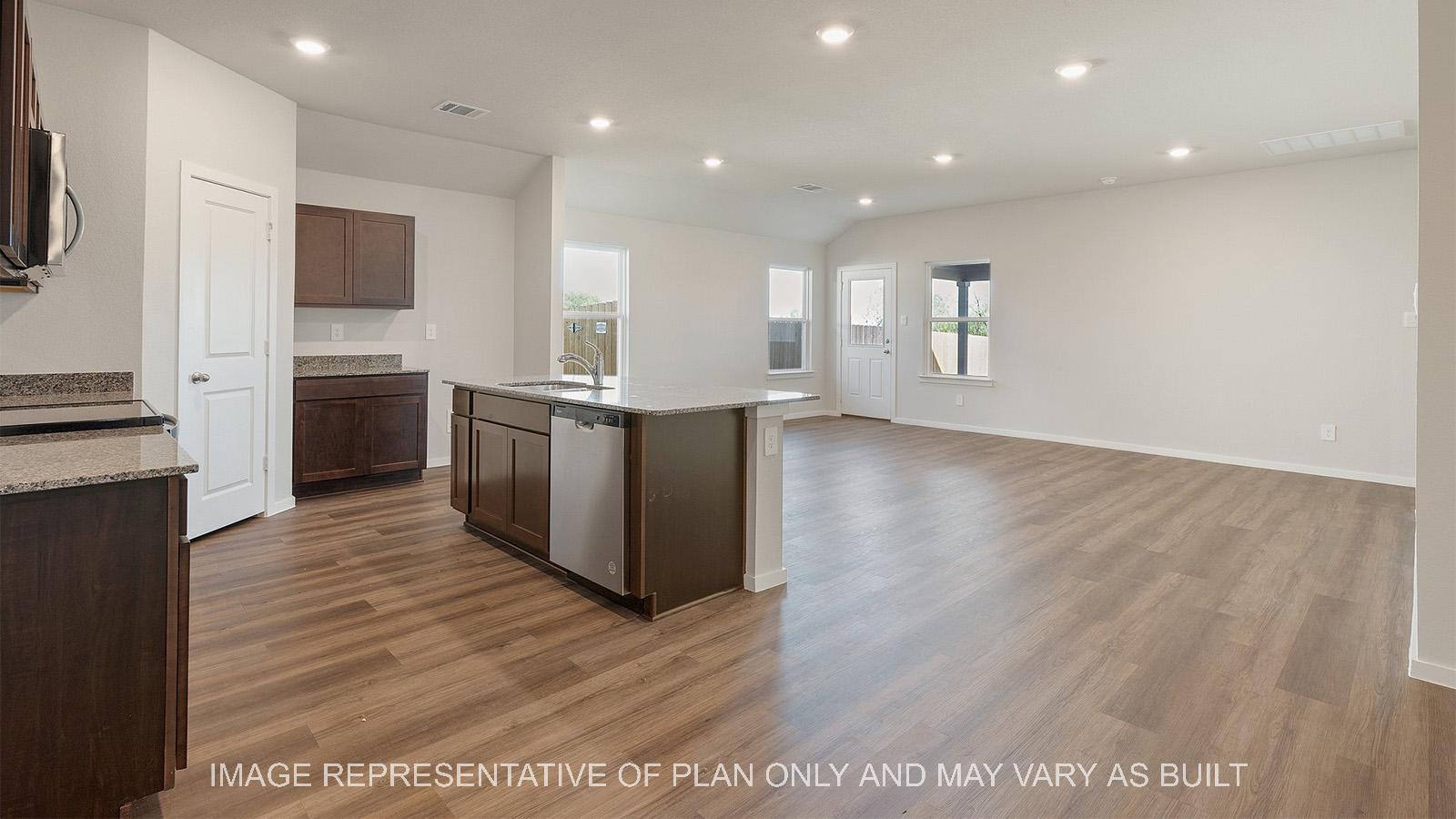 Lakeway kitchen with dark cabinets and kitchen island with view of living room.
