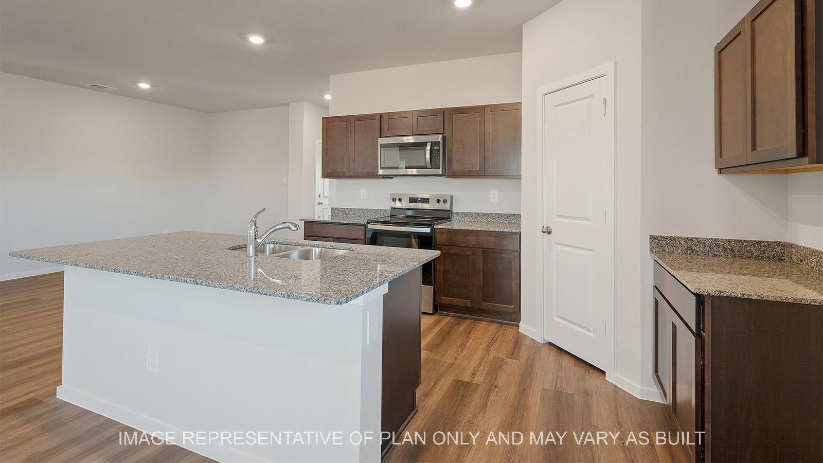 Lakeway kitchen with dark cabinets and kitchen island with view of dining room.