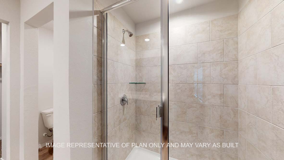 Ashburn primary bathroom with clear shower glass enclosure with ceramic tile shower surround.