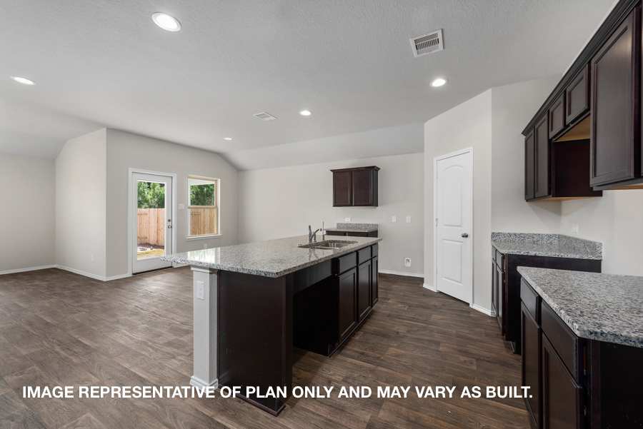 Kitchen with island and stainless-steel appliances.