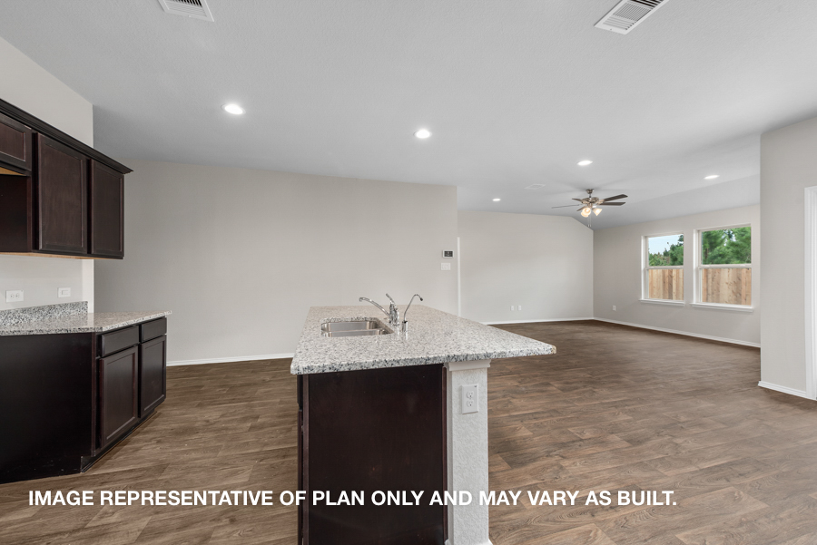 Kitchen with island and stainless-steel appliances.