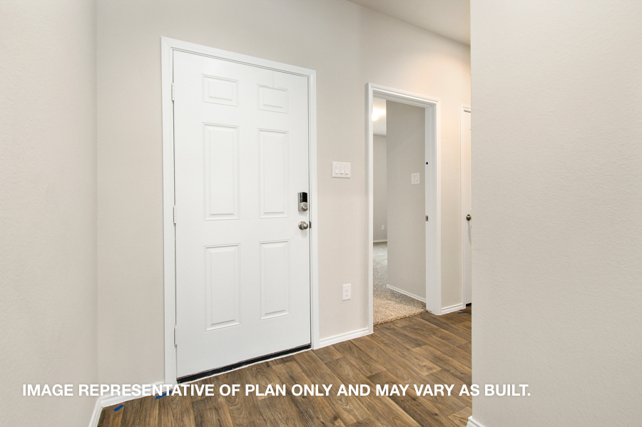 Entryway and foyer with vinyl flooring.