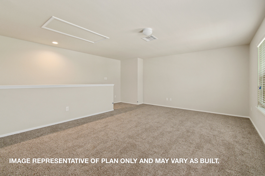 Upstairs game room with carpet flooring and bright windows.