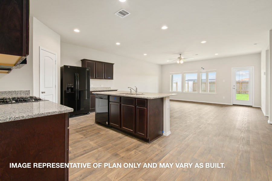 Kitchen with island and stainless-steel appliances.
