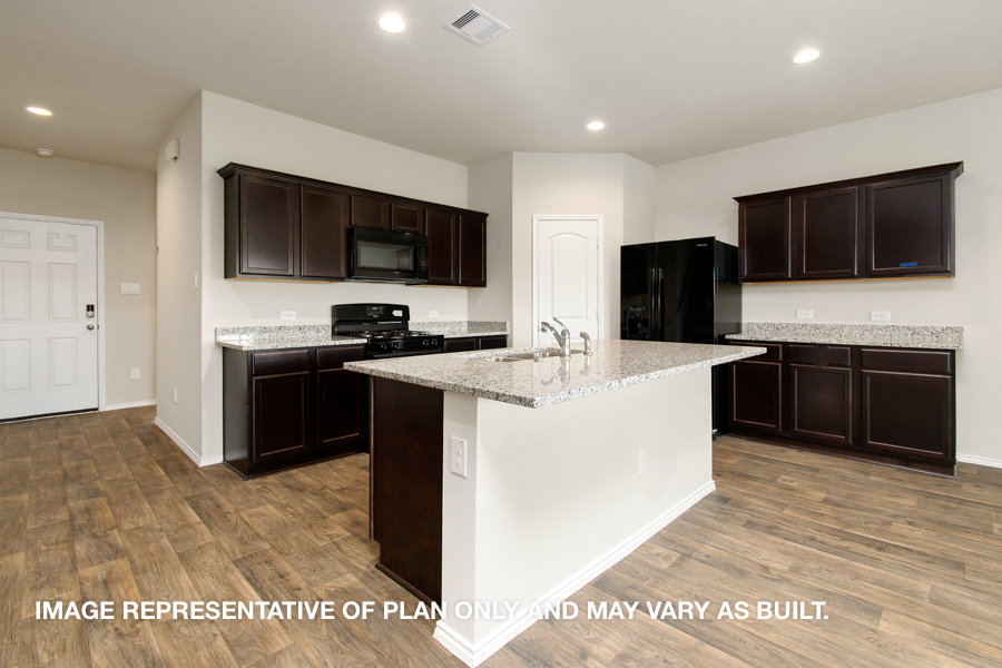 Kitchen with island and stainless-steel appliances.