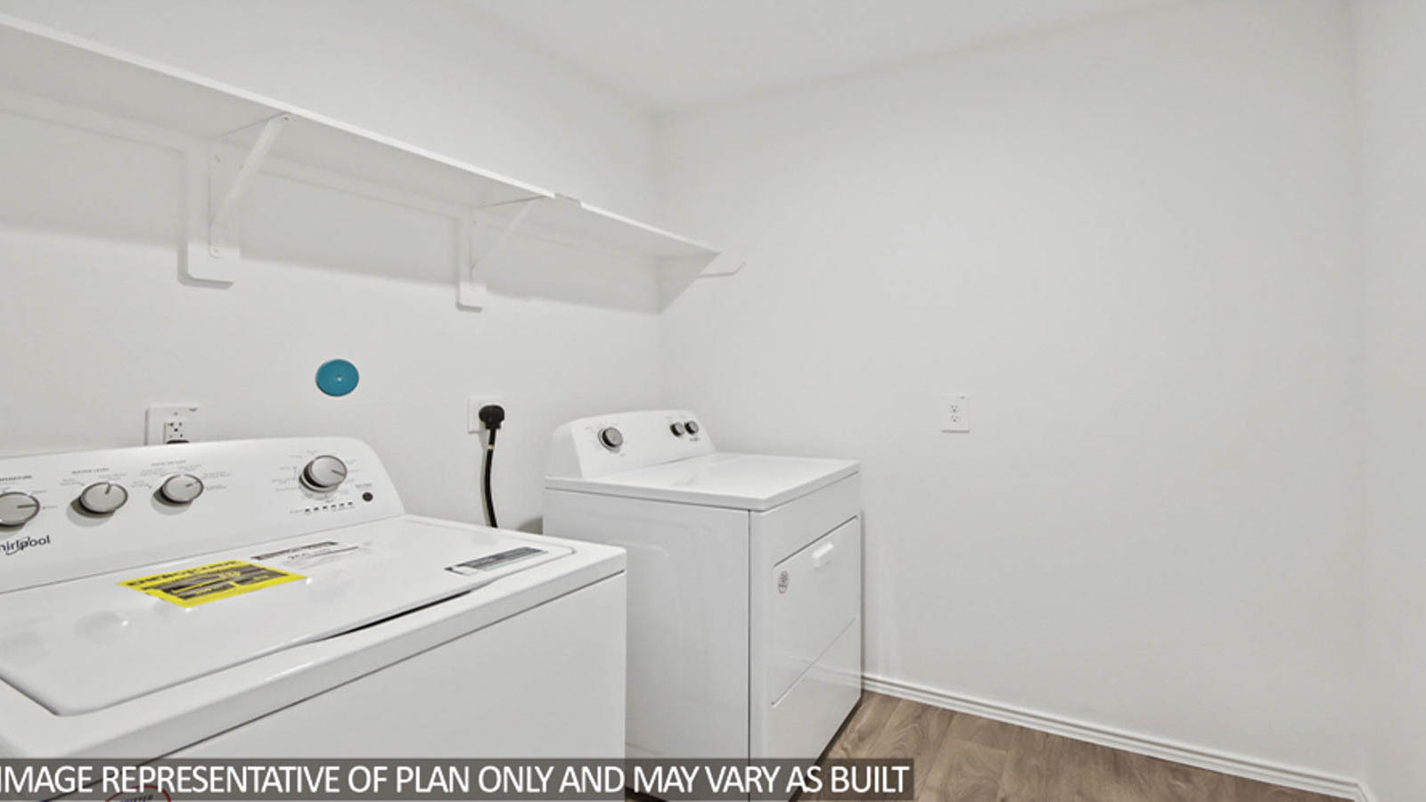 Utility room with storage located off the entry hallway and garage door