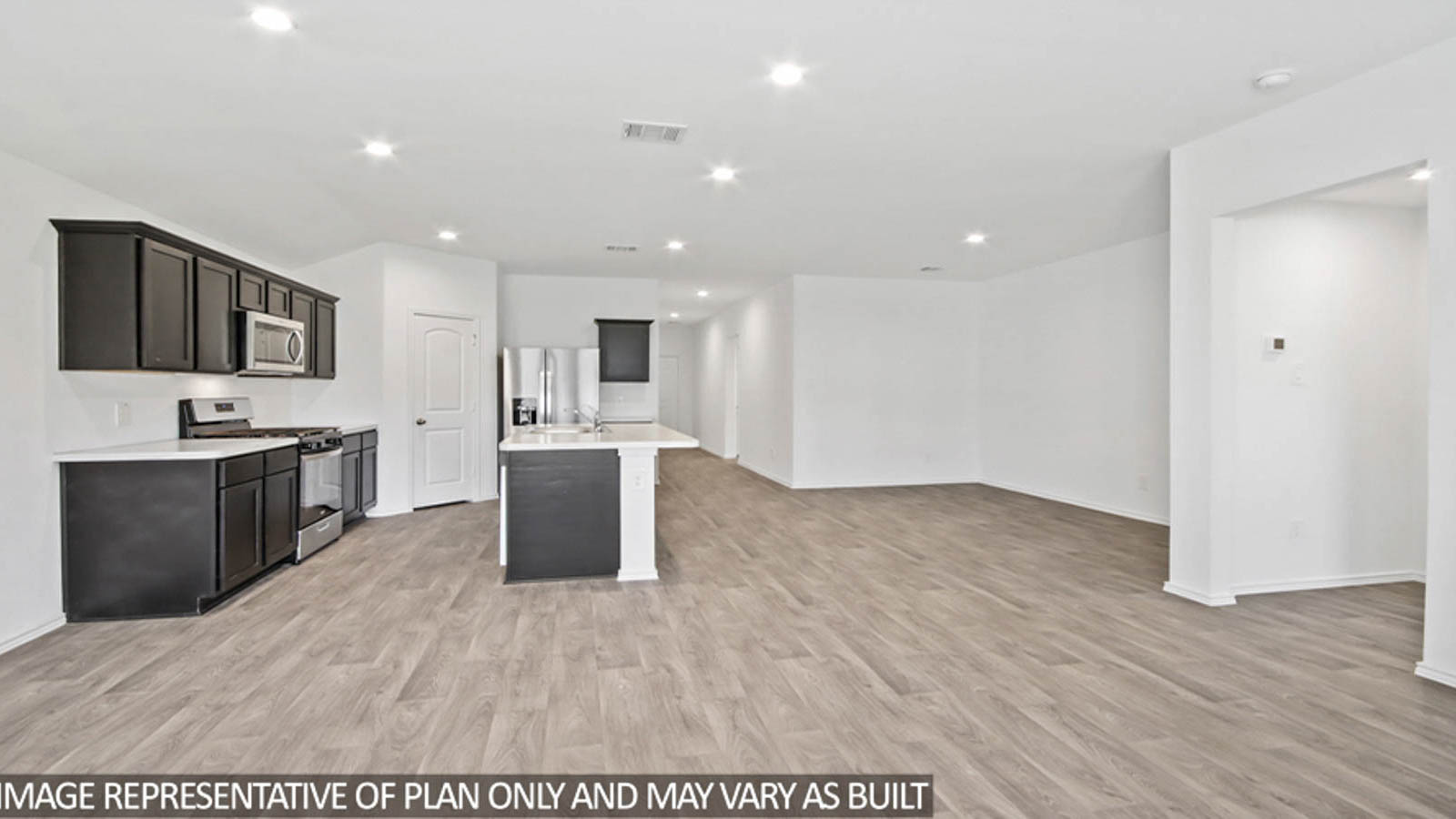 Kitchen with quartz countertops and marden hardware and an island and vinyl floor