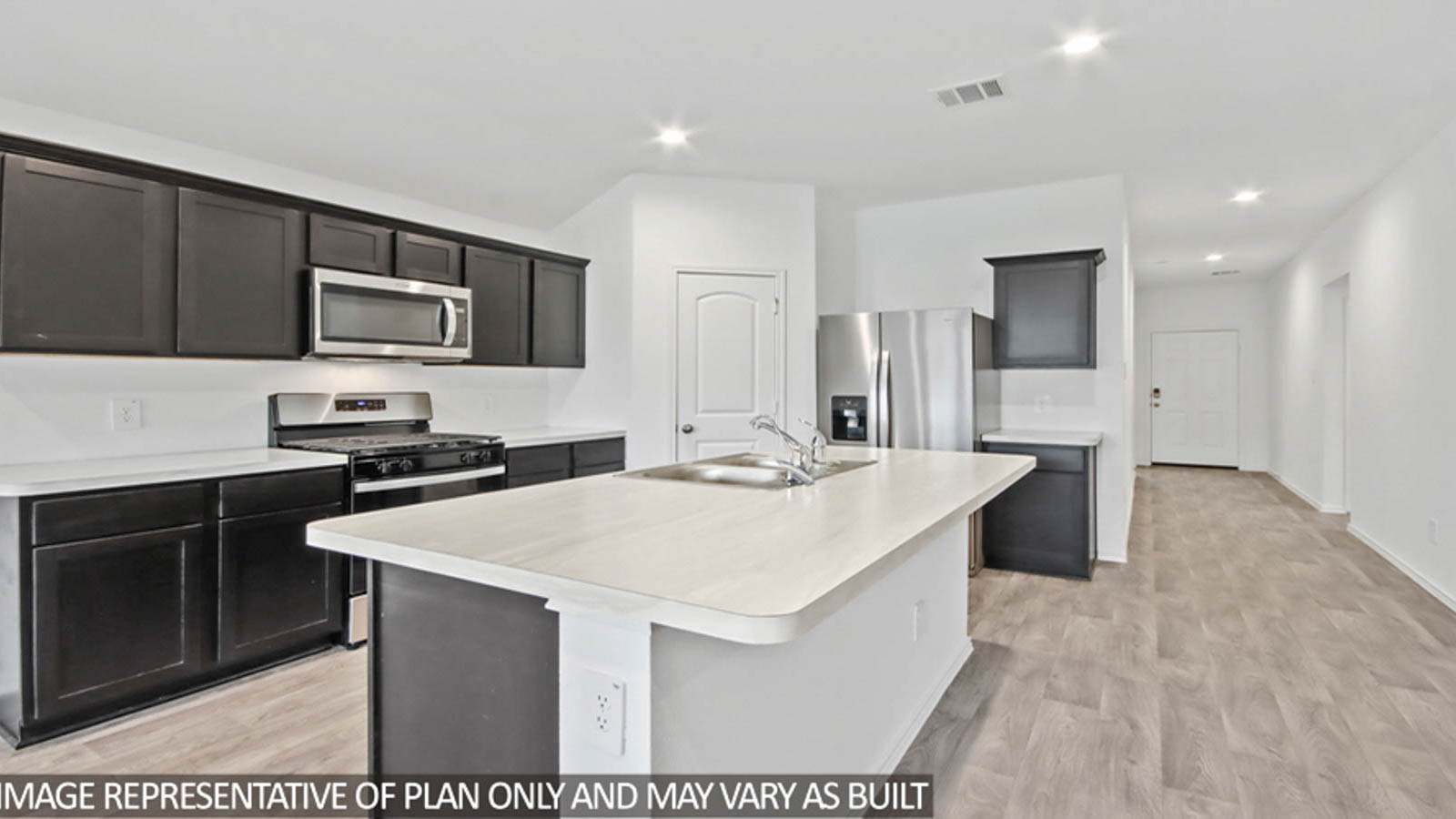 Kitchen with quartz countertops and marden hardware and an island and vinyl floor