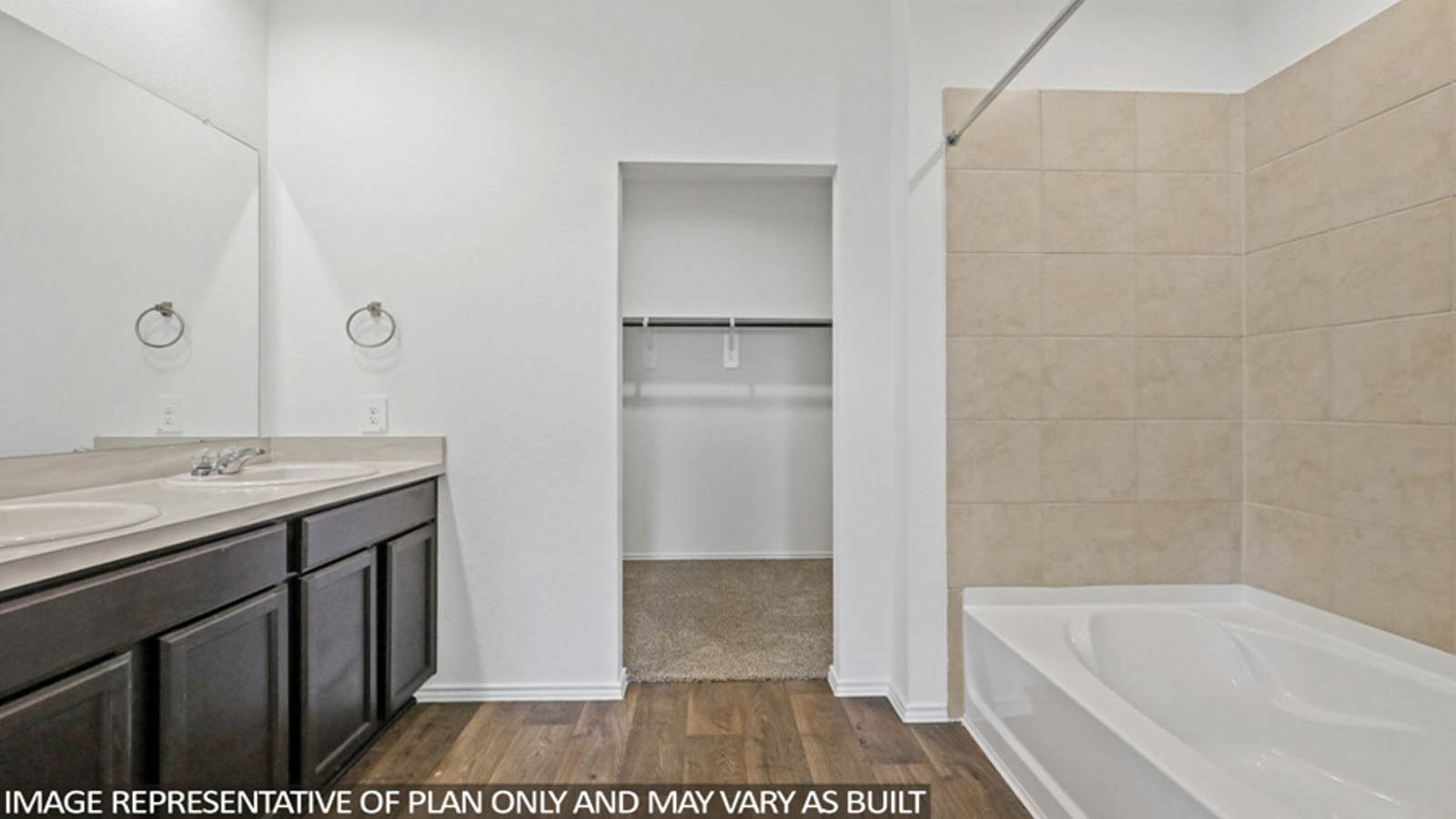 Primary bathroom with soaker tub and tile shower with semi frameless glass in Conroe TX