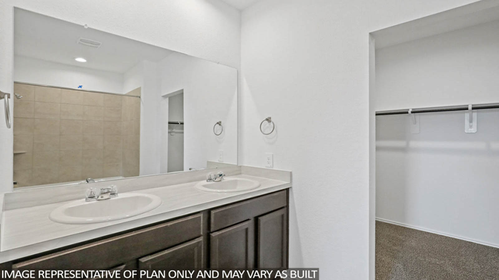 Primary bathroom with soaker tub and tile shower with semi frameless glass in Conroe TX