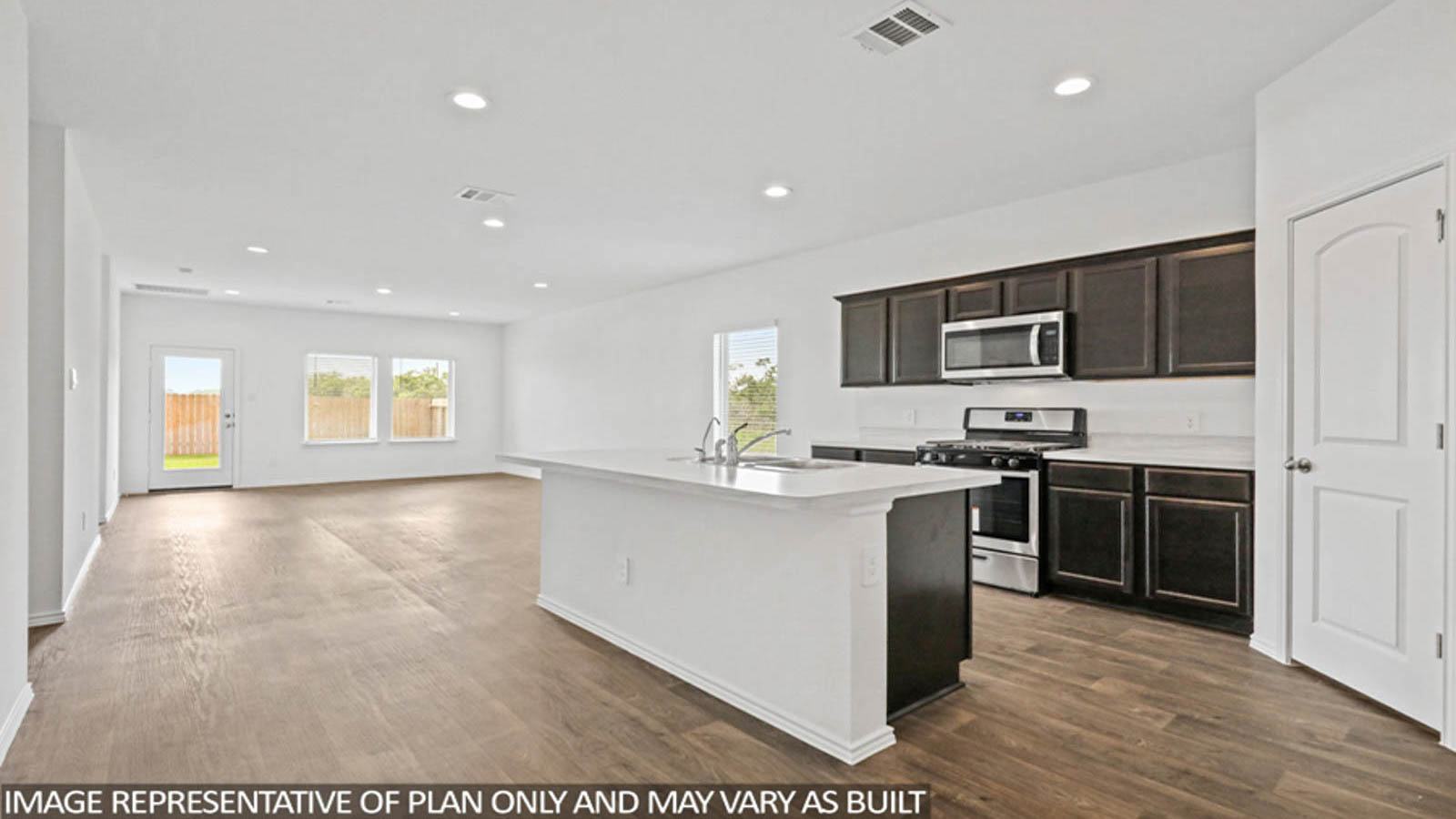 Kitchen with quartz countertops and marden hardware and an island and vinyl floor