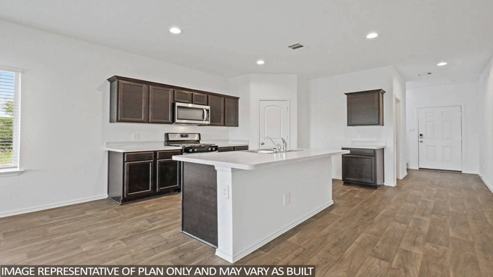 Kitchen with quartz countertops and marden hardware and an island and vinyl floor