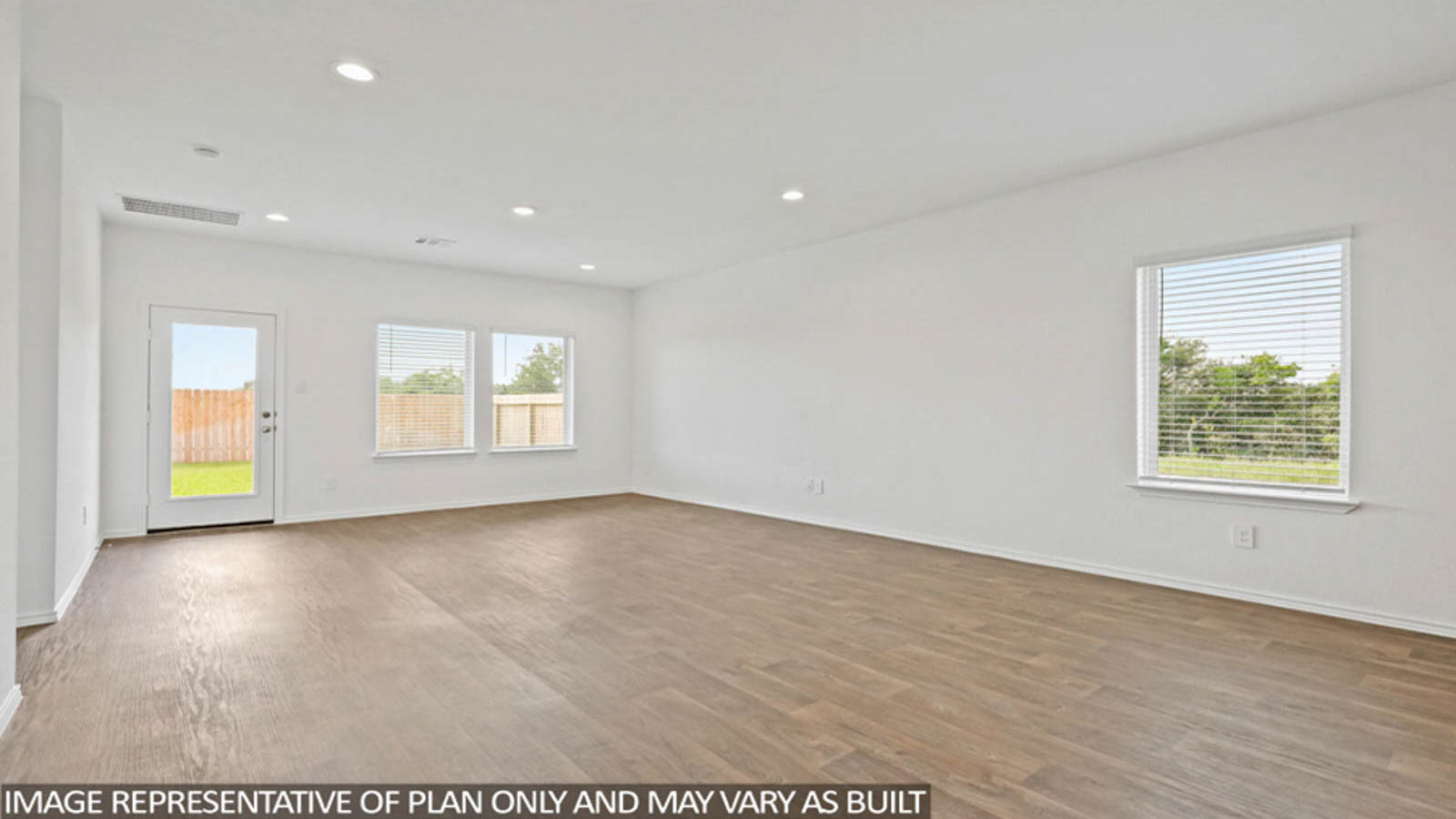 Spacious living area with vinyl flooring and bright windows in Conroe TX