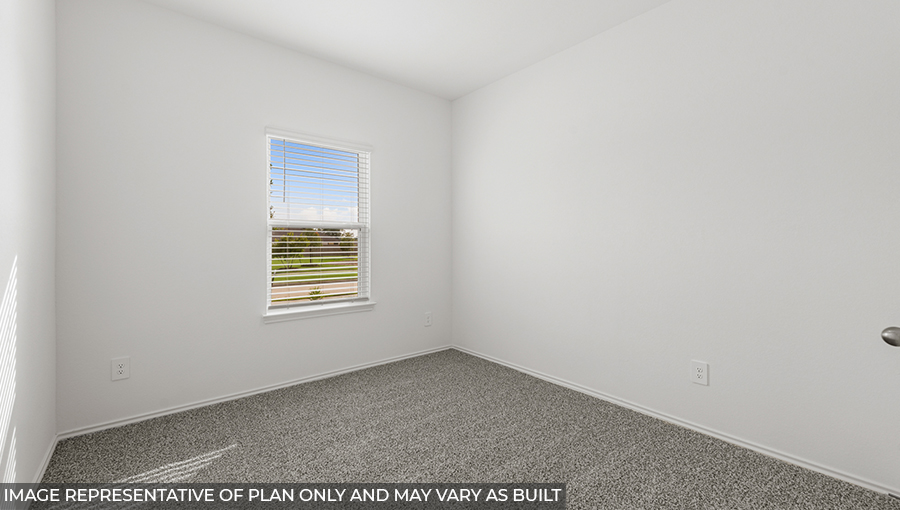 Secondary bedroom with shag carpet flooring and bright window