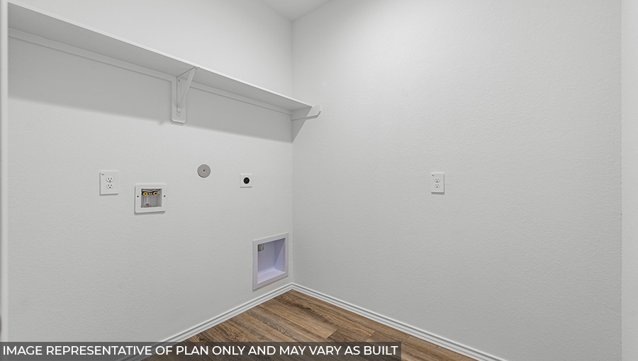 Utility room with storage located off the entry hallway and garage door