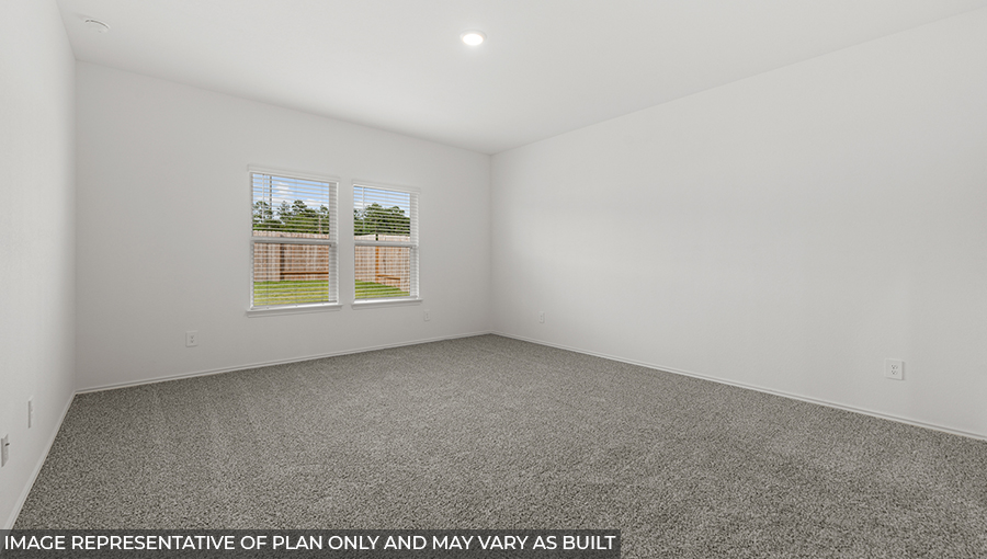 Large Primary bedroom with shag carpet flooring and bright window
