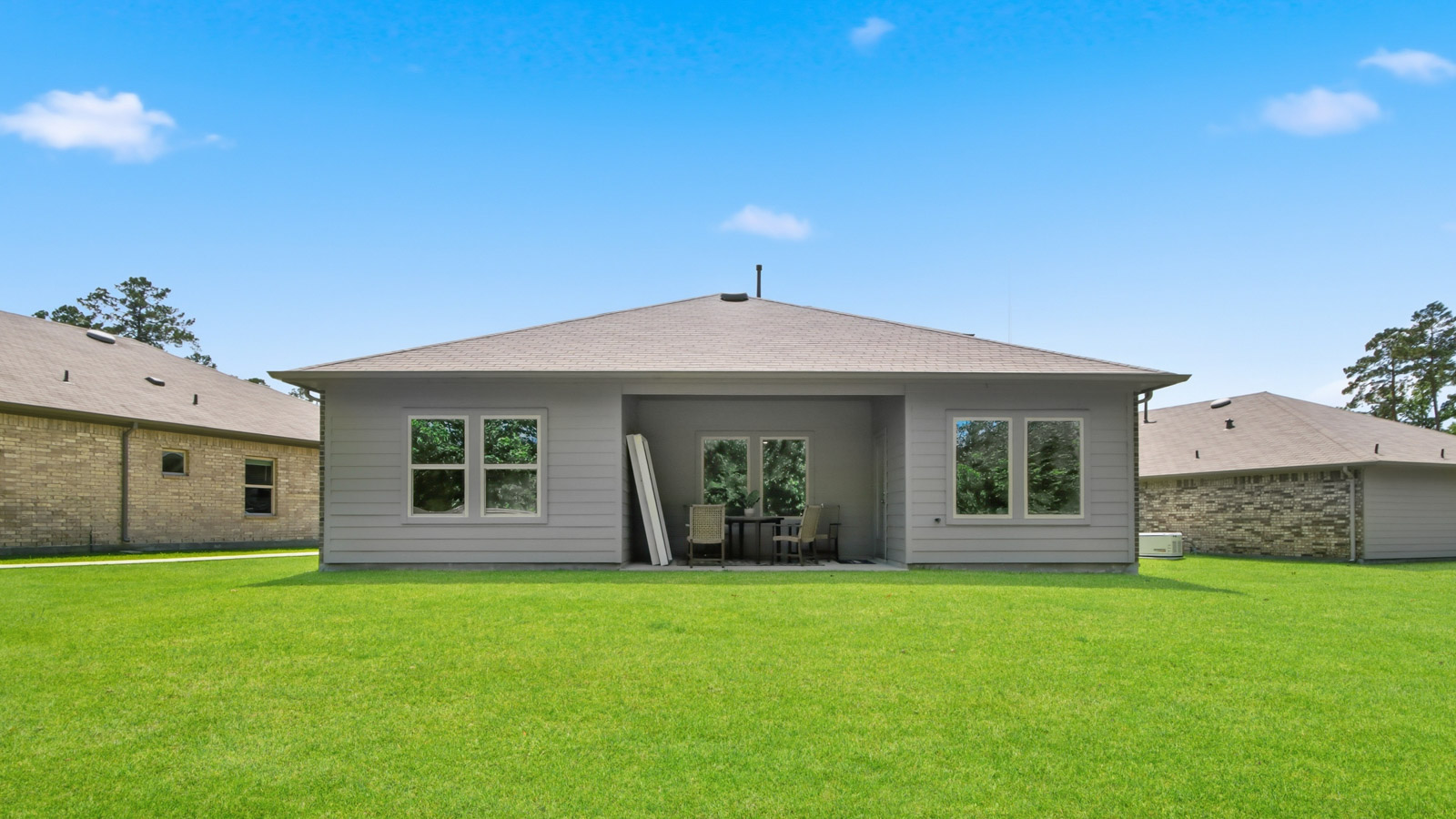 covered patio with jamies hardie siding and overhead lighting