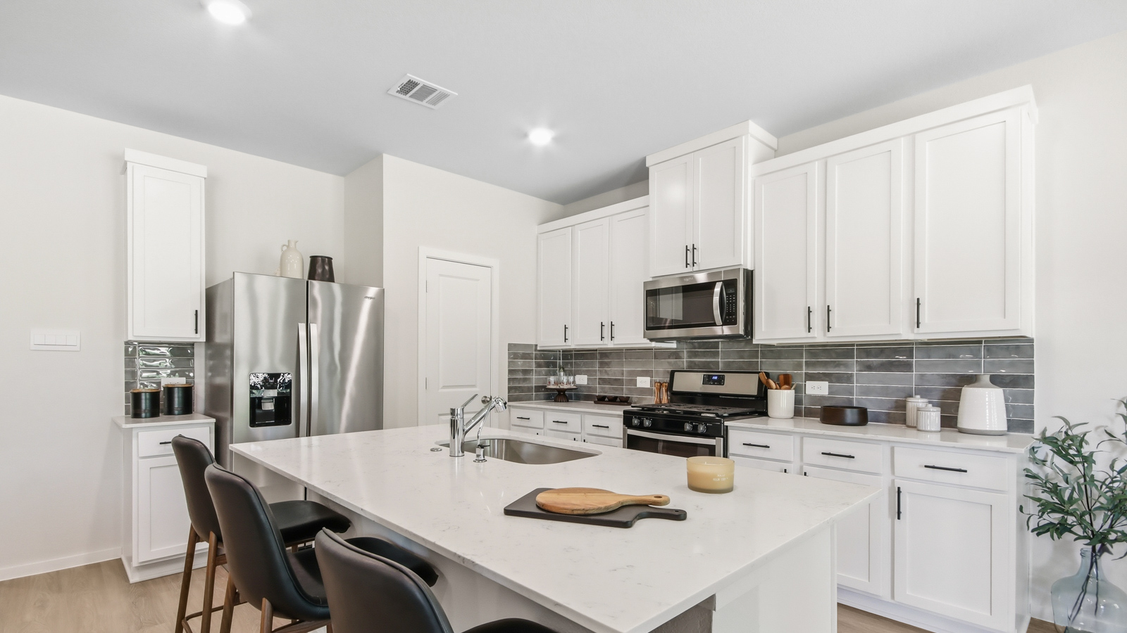 Kitchen with quartz countertops and an island and vinyl floor