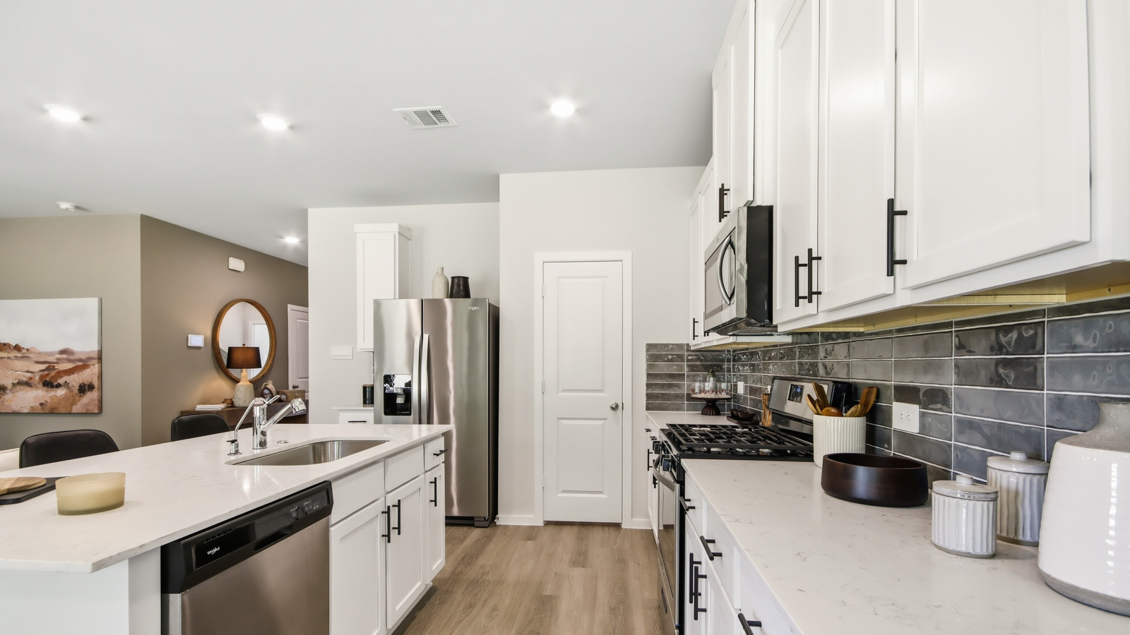 Kitchen with quartz countertops and an island and vinyl floor
