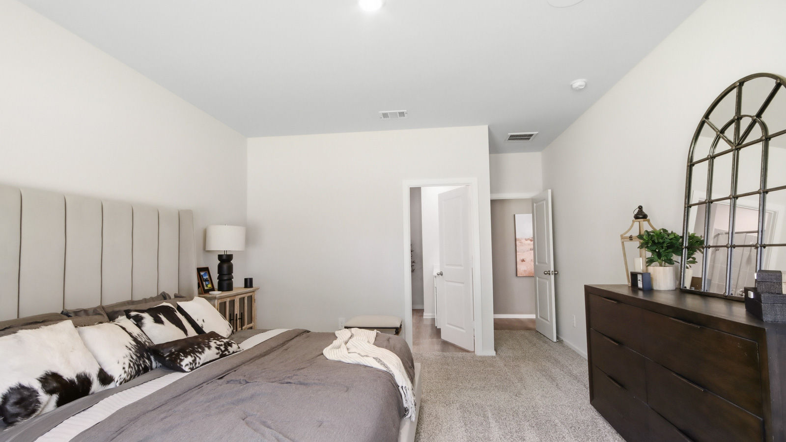 Large Primary bedroom with shag carpet flooring and bright window