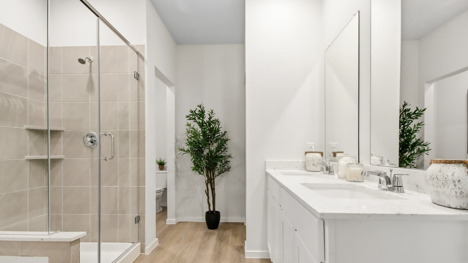 Primary bathroom with soaker tub and tile shower with semi frameless glass in Willis TX